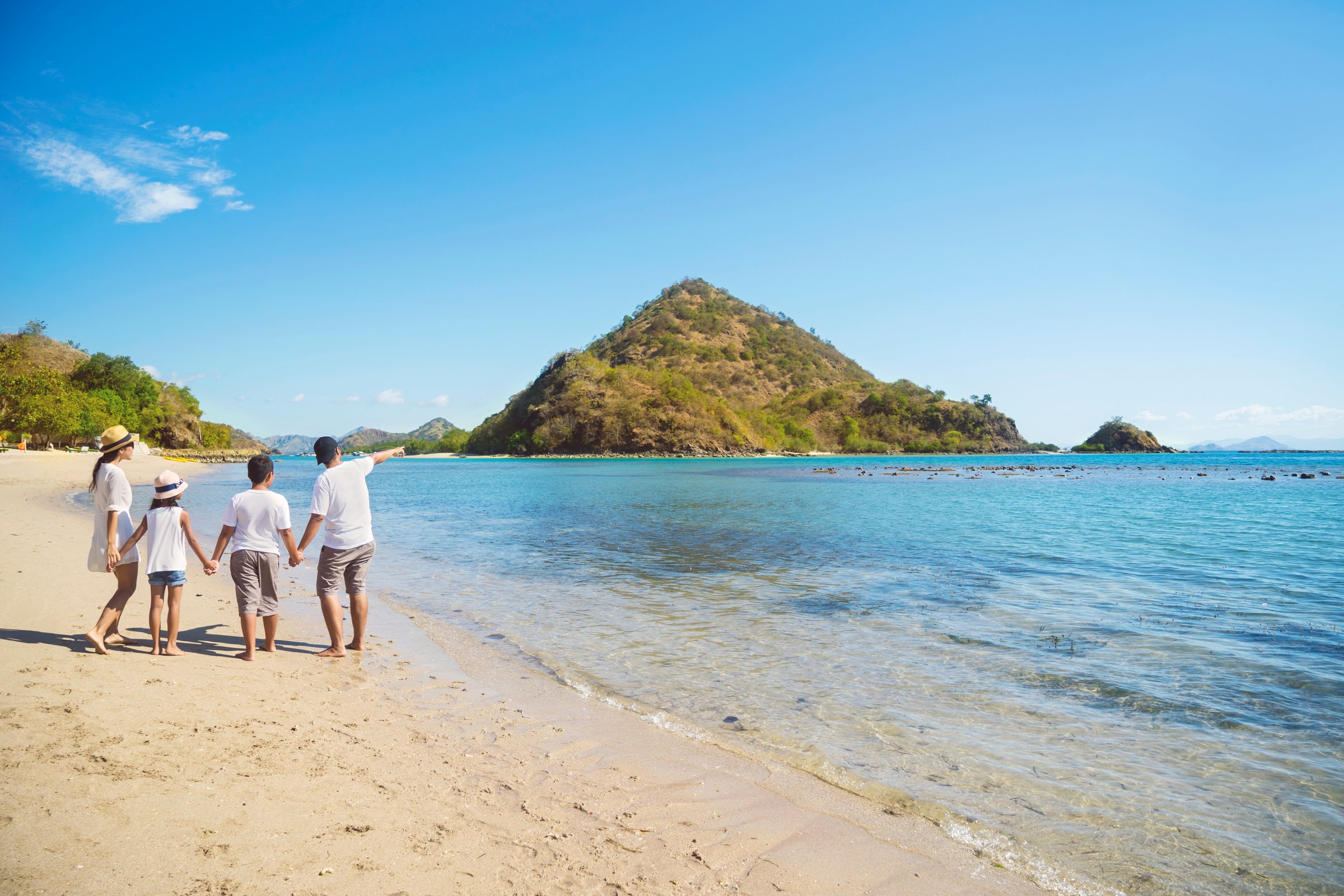 Asian Family Having a Holiday on the Beach